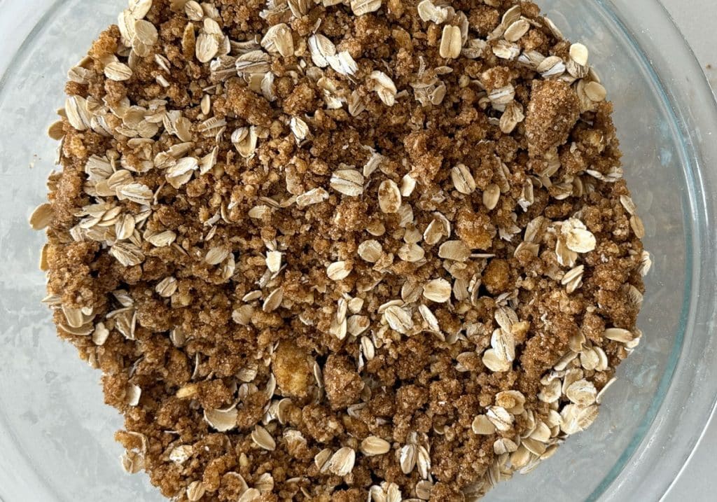 crisp topping in a glass bowl on a white counter top