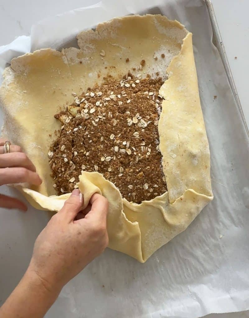 folding crust around the filling in the middle