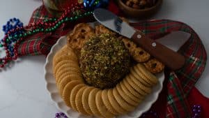 cheese ball with new years eve party favors and a glass of wine on a table