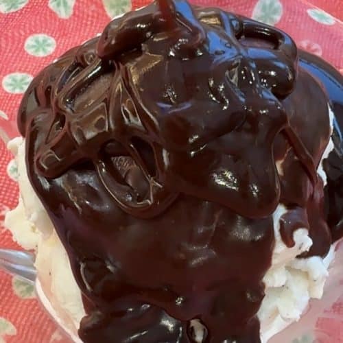 dish of vanilla ice cream with hot fudge getting poured over it