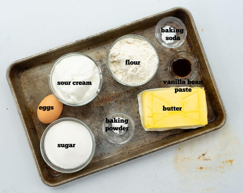ingredients for the easy classic pound cake on a baking sheet on a white counter top