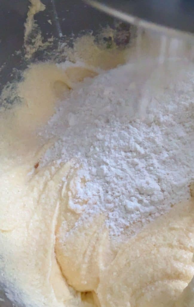 adding flour alternately with sour cream in mixing bowl