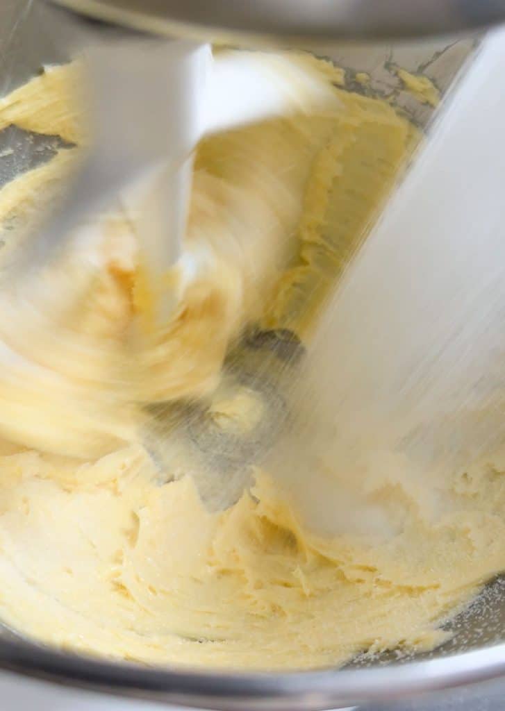 adding sugar to butter and mixing until light and fluffy