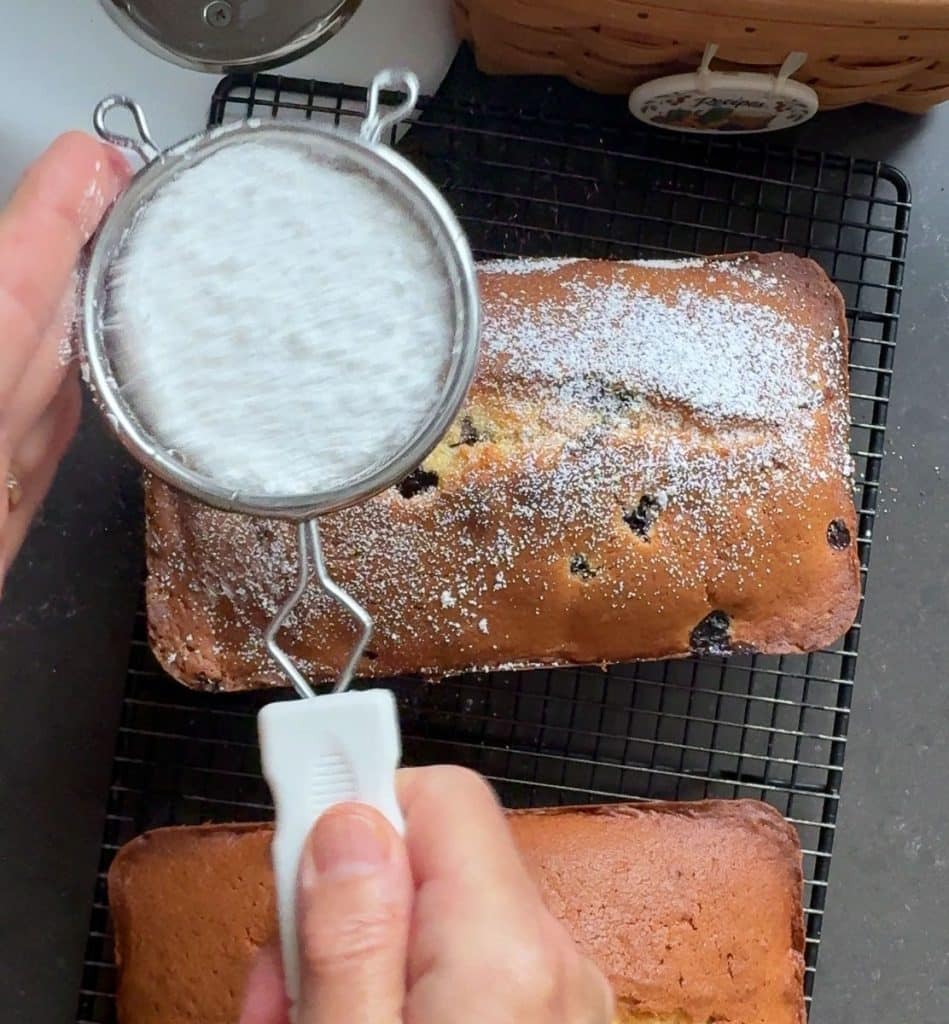 dusting pound cake with powdered sugar