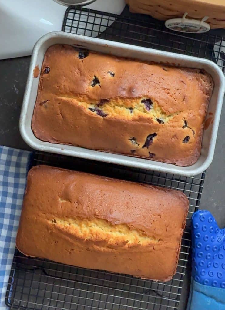 two loafs of pound cake on a cooling rack