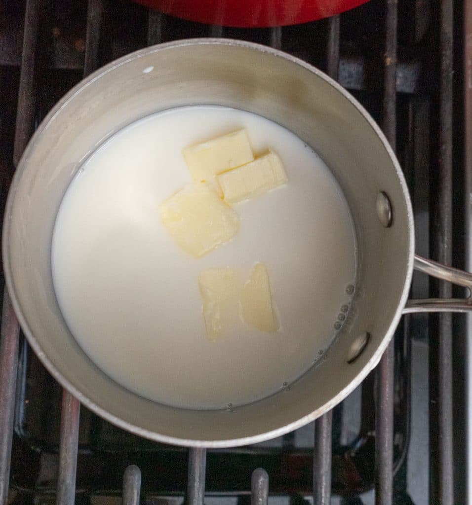 melting butter in whole milk in a saucepan on stovetop