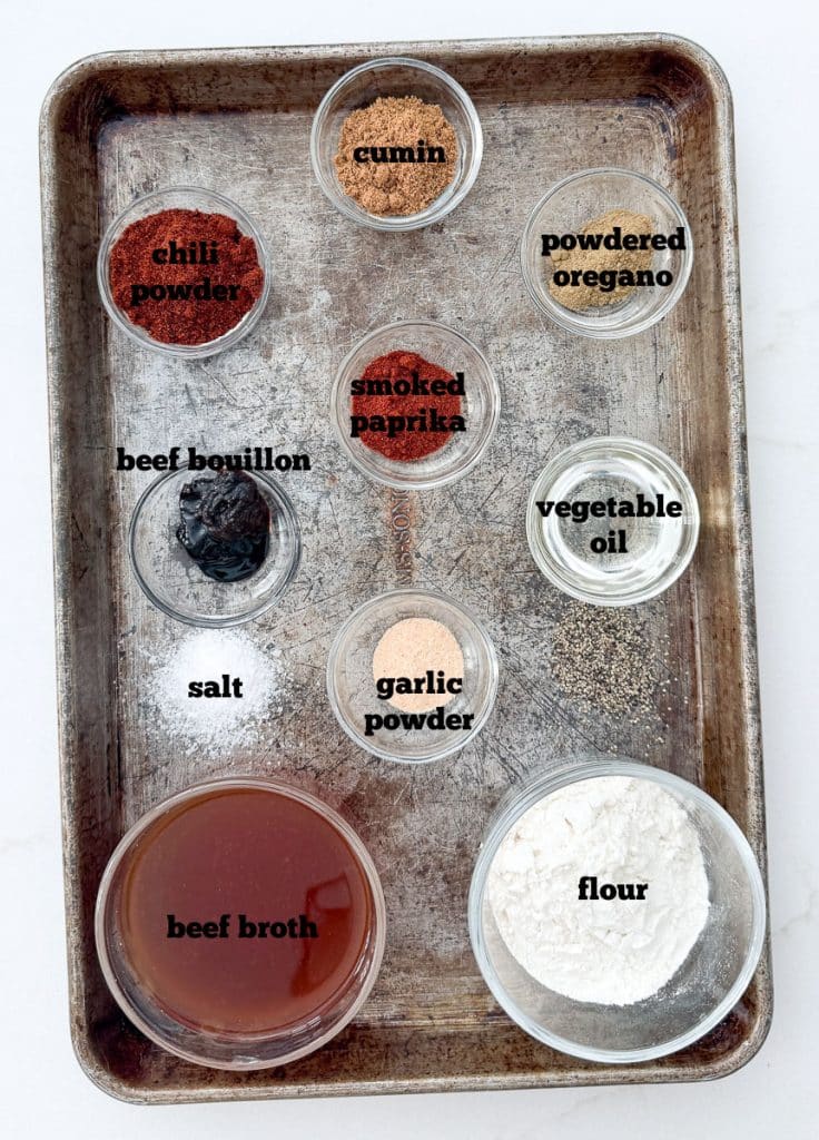 ingredients for red enchilada sauce on a baking sheet