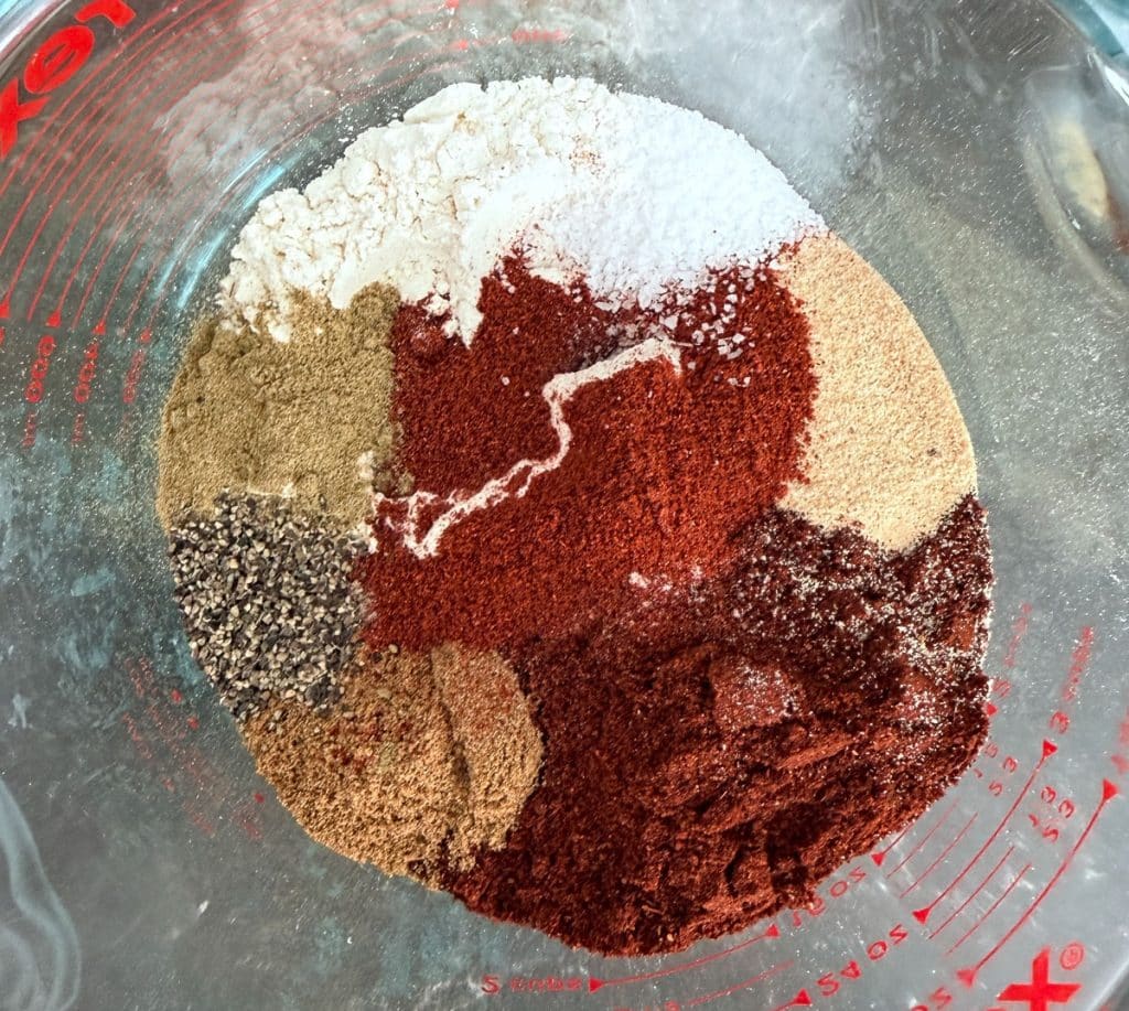 dry ingredients for red enchilada sauce in a glass bowl